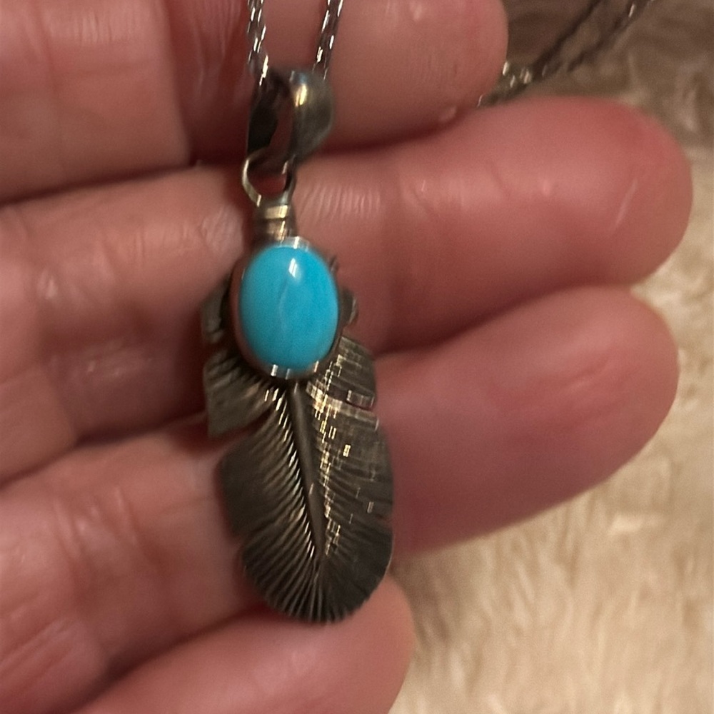 Sterling feather with sleeping beauty turquoise pendant in 925 sterling silver.